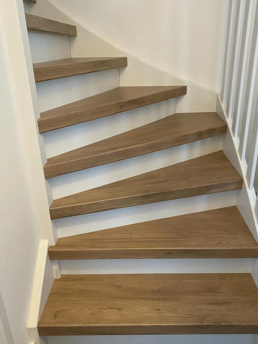 Traprenovatie in eiken met witte stootborden en witte spijlen
